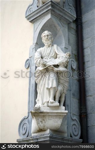 Sculpture saint with boy on the facade of church in Sanctuary of Betharram, France