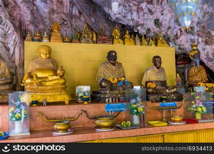 sculptures of monks and buddhas in the temple of Krabi in Thailand