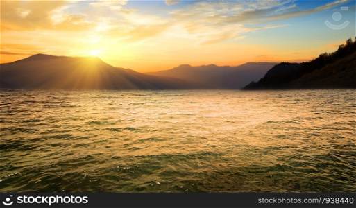 Sea and high mountains at the sunrise