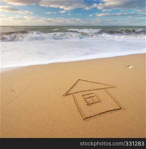 Sea and home on the sea sand. Nature and conceptual composition.