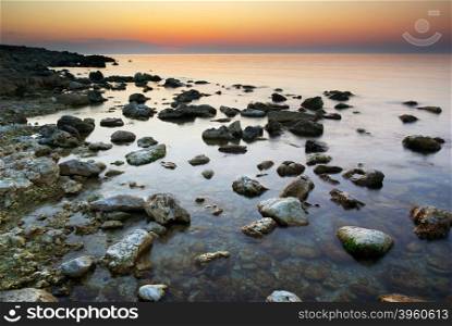 Sea and rock at the sunset. Nature composition.