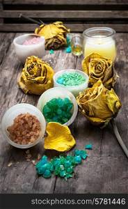 sea aromatic salt for Spa treatments on the background of yellow rose buds. sea aromatic salt for spa treatments