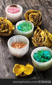 sea aromatic salt for Spa treatments on the background of yellow rose buds. sea aromatic salt for spa treatments