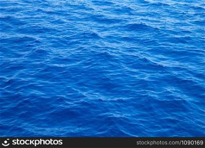 Sea background . Blue water with sun reflections