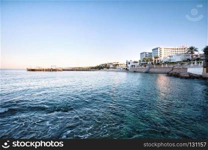 Sea bay with hotels on the coast during the day. Sea bay with hotels on the coast