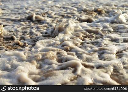 sea beach. Stones on sand are washed by sea waves