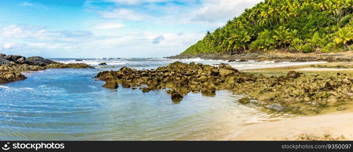 Sea between vegetation and rocks at Prainha beach in Serra Grande on the south coast of Bahia. Sea between vegetation and rocks at Prainha beach