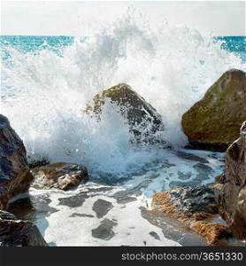 Sea, big wave and splash over the stones
