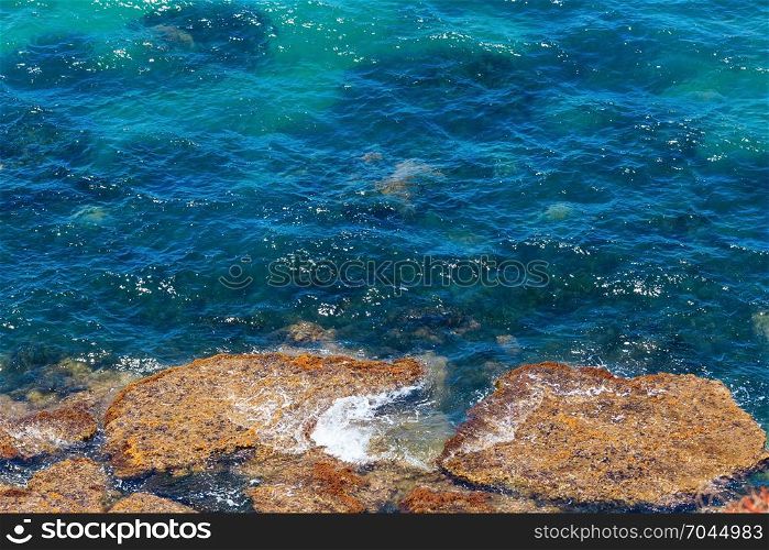Sea coast view with transparent aquamarine water (nature background), Sicily, Italy.