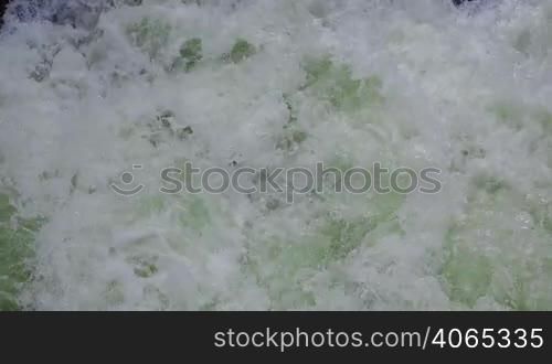 Sea foam in green waves