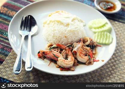 Sea food with basil and egg served with rice