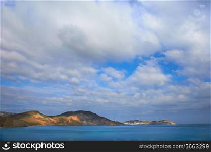 Sea harbor with blue water, islands and blue sky with clouds