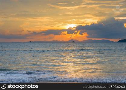 sea landscape at sunset in blue and orange tones in Thailand