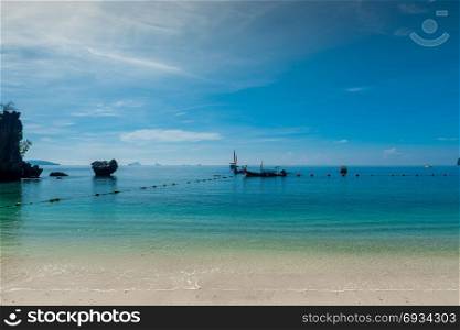 sea landscape in blue colors - traditional Thai boats in the sea