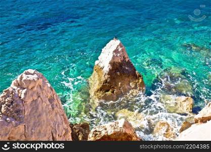 Sea landscape. Rocks in turquoise sea view. Sunny bright environment.