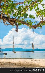 sea landscape with a swing in the foreground, a photo from Thailand