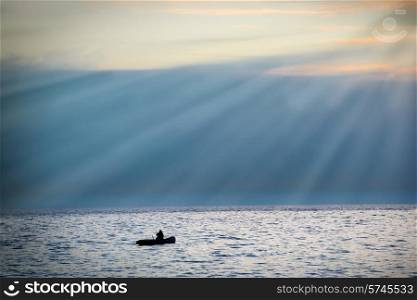 Sea landscape with boat against dramatic sunset