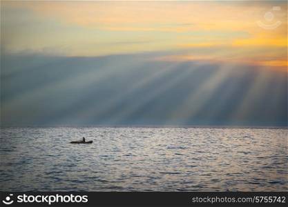 Sea landscape with boat against dramatic sunset
