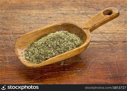 sea lettuce flakes on a rustic wooden scoop against grunge wood