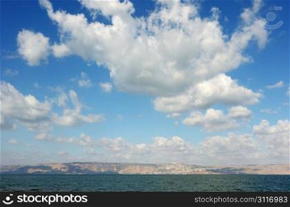 Sea of Galilee in the early morning, ripples on the water and clouds in the sky