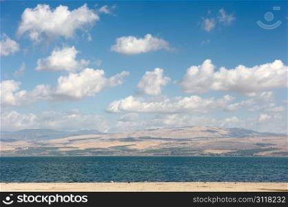 Sea of Galilee in the early morning, ripples on the water and clouds in the sky
