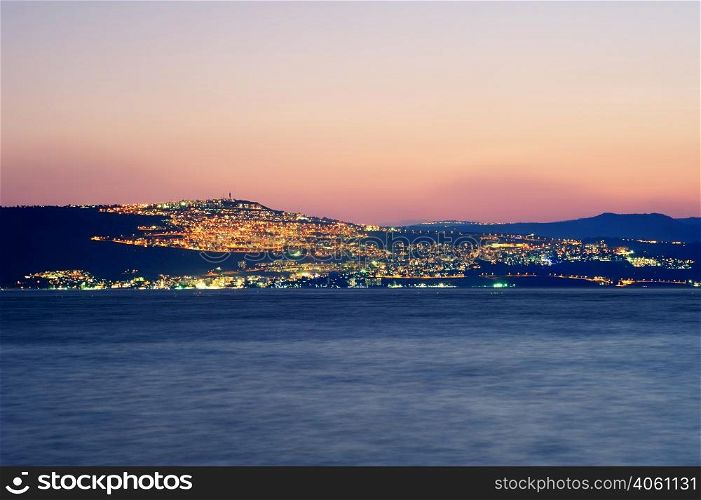 Sea of Galilee (Kinneret), the largest freshwater lake in Israel. Lake Kinneret on the Sunset and the lights of Tiberias