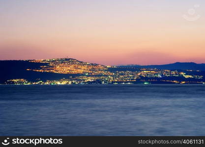 Sea of Galilee (Kinneret), the largest freshwater lake in Israel. Lake Kinneret on the Sunset and the lights of Tiberias