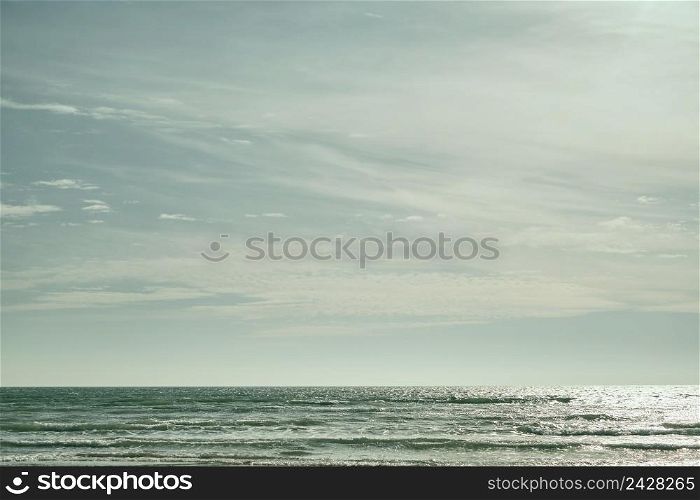 Sea on sunny, cloudy sky background. Beautiful cloudy spring sky on a bright sunny day. Turquoise afternoon on the sandy beach of the Black Sea. High quality photo