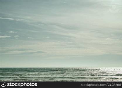 Sea on sunny, cloudy sky background. Beautiful cloudy spring sky on a bright sunny day. Turquoise afternoon on the sandy beach of the Black Sea. High quality photo
