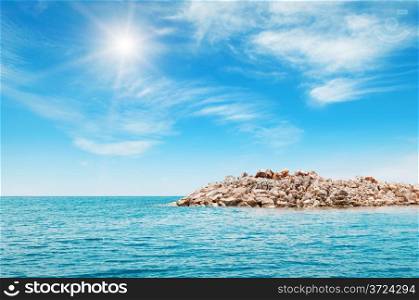 sea, rocky shore and blue sky