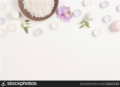 sea salt orchid flower with candles white background forming top border