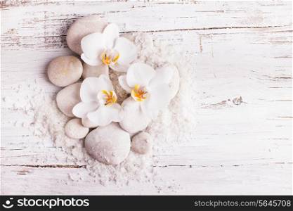 Sea salt, rebbles with orchids with copy space