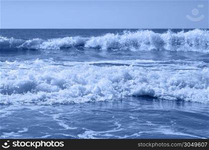 Sea, sand ,sky and dramatic waves and summer day. Beautiful tropical beach. Beautiful beach and tropical sea. Seacoast Summer concept Banner toned in blue color of the year 2020. Sea, sand ,sky and dramatic waves and summer day.