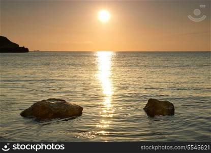 Sea shore and stones. Seascape at sunset.