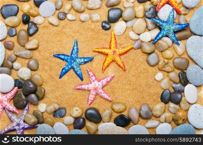 Sea stars and pebbles on sand