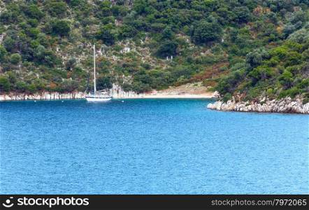 Sea summer coast view with yacht near small beach (Greece)