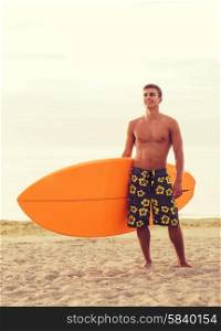 sea, summer vacation, water sport and people concept - smiling young man with surfboard on beach