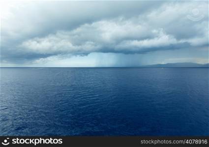 Sea summer view (with stormy sky and rain on horizon) from train ferry on way from Kefalonia to Ithaca(Greece)