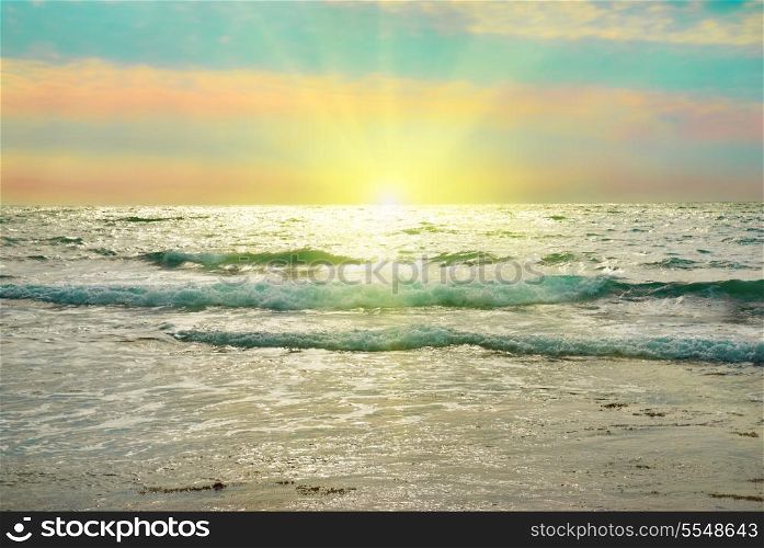 Sea, sun, waves and clouds. Sunset above the sea