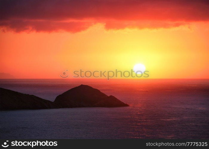 Sea sunset. Seascape sunset with island. Sun setting down in sea. Crete island, Greece. Sea sunset in Greece