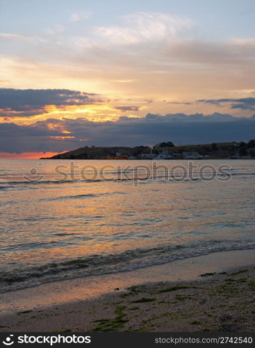 Sea sunset with cape and ships. Two shots composite picture.