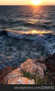 Sea sunset with surf and rocky coast