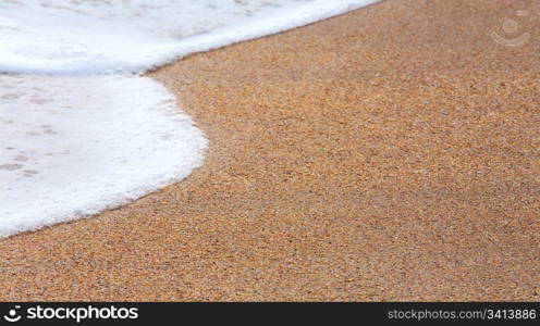 Sea surf foam on coastline sand