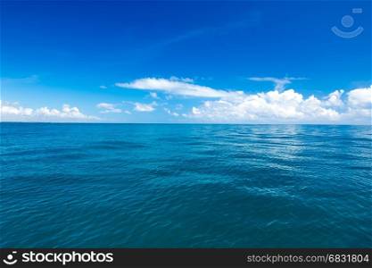 sea surface summer wave background. Exotic water landscape with clouds on horizon.