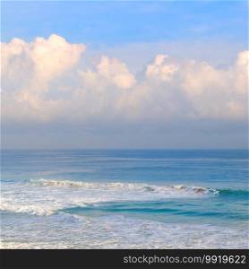 Sea surface summer wave background. Exotic water landscape with clouds on horizon. Natural tropical water paradise.