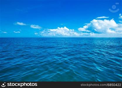 sea surface summer wave background. water landscape with clouds on horizon. Natural tropical water paradise. Ocean nature tranquility