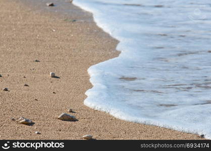 Sea view at a pebble beach, little waves, turquoise water, tranquil scene