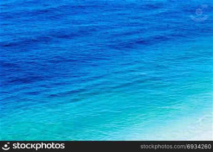Sea view at a pebble beach, little waves, turquoise water, tranquil scene