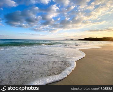 Sea view from tropical beach with sunny sky in the evening. Summer beach with clouds on horizon. 