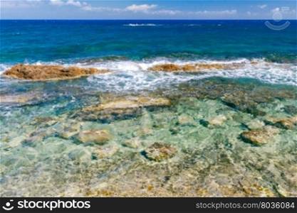 Sea views, waves and stones on a sunny day. Crete. Greece.